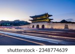 Small photo of Gyeongbokgung palace in Seoul City, South Korea during a blue hour with light trails of passing traffic visible in foreground. Korean text translated to english says Gwanghwamun, whis is name of gate.