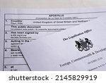 Small photo of Authentic apostille document from The UK Legalisation Office. Legalised document with the stamped official certificate. Stafford, United Kingdom, April 13, 2022.
