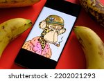 Small photo of Bored Ape #6723 NFT seen on the smartphone screen surrounded by rotten bananas. Snoop Dogg’s NFT. Stafford, United Kingdom, September 11, 2022.