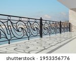 Wrought iron railing. 3D render for project. Forging metal. Balcony. Terrace. Architecture. Luxury hotel. Sea view. Iron fences. White handrails with gold decor. Summer vacations. Blacksmithing.