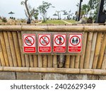 Small photo of bali, indonesia-10 september 2023 : signs prohibit swimming, prohibited crossing boundaries, prohibited littering at the Taman Danu tourist lodge