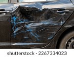 Small photo of accidental damage to the door of a black car