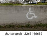 a wheelchair symbol with parking space on a wall in the city