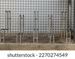 bicycle stand in front of a modern metal wall in the city