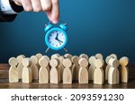 Small photo of A businessman is holding an alarm clock over a crowd of people.Time management. Hourly wages, strict work limits and time allotted for rest. Urgently, speeding up, deadline. Test, trial period