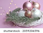 Small photo of Christmas decorations in pastel colors, christmas wreath, spruce branch. Christmas background. delicate colors. pink, purple, lilac, white glamour color, light tones. yappy new year. bulb, toys