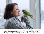 Middle aged woman and parrot...