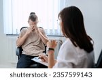 Small photo of Young male student at therapy meeting with college psychologist counselor