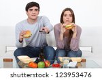 Young couple eating burgers