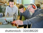 Senior carpenter with two learners