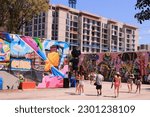 Small photo of Miami, Florida, USA - April 08, 2023: tourists visit the graffiti murals and street art art Wynwood Walls Art and Design District.