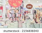Small photo of Blurred bookshelves of bookstore with colorful books, glass showcase. Education, school, study, reading fiction concept. Abstract background