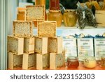 Small photo of Jars of honey, Honey in honeycombs, production of honey. Gastronomic farm market counter, real scene