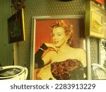Small photo of Marylin Monroe on canvas is a photo taken in an antique shop in Italy, in Naples on March 25, 2023. The subject in the photo is a painting by Marylin Monroe