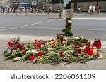 Small photo of Berlin June 2022: Mourners laid flowers and candles at the scene of an accident after a mentally ill man ran amok into a crowd of people, killing a 51-year-old woman.
