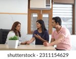 Small photo of Happy Indian couple getting checkup by gynecologist to make sure that mother is expecting baby. Young woman patient with husband getting checked up by senior gynecologist during consultation. Smiles