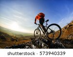 back view of a man with a bicycle and red backpack against the blue sky. cyclist rides a bicycle. Rear view people collection. backside view of person. blue sky background and mound.