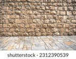 Background with an ancient brick wall and pavement of old city of Jerusalem, Israel