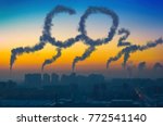Evening view of the industrial landscape of the city with smoke emissions from chimneys at sunset CO2