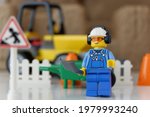 Small photo of Tangsel, Indonesia - April 30, 2021: lego guy minifigs in happy mood to work alone to repair the road. lego minifigs are made by the lego group.