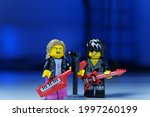 Small photo of Tangsel, Indonesia - June 26 2021: duo rockstar perform with electric guitar and keytar in low key and blue light in the background. lego minifigs are made by the LEGO Group