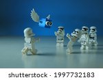 Small photo of Tangsel, Indonesia - May 18 2021: Lego first order trooper amaze with floating blue cube with wings. lego minifigs are made by the LEGO Group