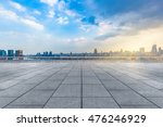 empty brick floor with city skyline background