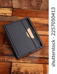 Small photo of Styli's corporate gift box, styli's leather note book stock image, note book and diary isolated wooden background top view mockup image