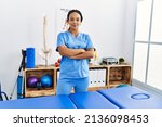 Small photo of Young african american woman wearing physio therapist uniform standing with arms crossed gesture at clinic