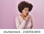 Small photo of Young african american woman standing over pink background hand on mouth telling secret rumor, whispering malicious talk conversation