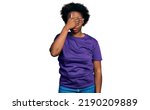 Small photo of African american woman with afro hair wearing casual purple t shirt covering eyes with hand, looking serious and sad. sightless, hiding and rejection concept