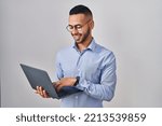 Small photo of Young hispanic man working using computer laptop with a happy and cool smile on face. lucky person.