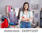 Small photo of Young caucasian woman tailor smiling confident standing with arms crossed gesture at tailor shop