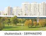 View of houses in Moscow and the overground metro line in the park area.
