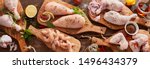 Panorama banner of raw chicken portions for cooking and barbecuing with skinless breasts and diced strips for goulash or stir fry with legs and wings with skin viewed from above with fresh seasoning