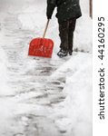Small photo of Man shoveling snow from the sidewalk in front of his house after a calamitous snowfall in a city