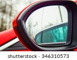 Blind Spot Monitoring system warning light/icon in side view mirror of a modern vehicle.