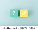 Small photo of Concept of searching for solution or ideas, doubts, uncertainty and final good result. Question sign and checkmark on yellow and blue toy cubes on bright pastel pink background.