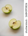 Small photo of Slices of green healthy and antitoxin apple fruits on a white background