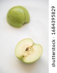 Small photo of Slices of green healthy and antitoxin apple fruits on a white background