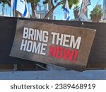 Small photo of Tel Aviv, Israel - November 15, 2023: Campaign to release the Israeli hostages, kidnapped by Hamas. Tel Aviv Museum of Art Square. Slogan Bring Them Home Now sign.