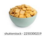 Cookie crackers in a plate on a white background. Lots of salty cookies on a plate.