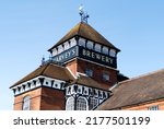 Small photo of Lewes, Sussex, UK - June 15 2022: Detail of the Bridge Wharf Brewery buildings, home to Harvey's Brewery in Lewes, Sussex, UK. A view of the tower with the words "Harvey's Brewery".