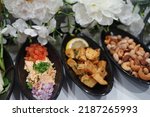 Small photo of Entree Event Catering Food, Table Styling Event Appetisers, Food at event Wedding Party. Detail Close up Presentation of Entree Food Canapes. Dinner restaurant catering food.