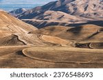 Small photo of The quaint natural hilly landscape of Kyrgyzstan. The relief of the hills is created by tectonic action. Natural background of the earth's surface.