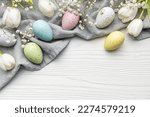 Happy Easter holiday greeting card. Bouquet of white tulips and Easter egg on white wooden background. Space for text