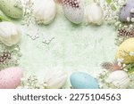 Happy Easter holiday greeting card. Bouquet of white tulips and Easter egg on green wooden background. Space for text