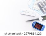 Medical kit for the prevention and treatment of coronavirus. Mask, test, pulse oximeter and medication on a white background.