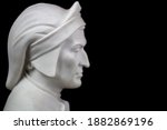 Small photo of Close-up of face profile about knick knack depicting Dante Alighieri in plaster on a black background