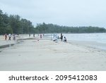 Small photo of Port Dickson, Negari Sembilan, Malaysia - December 19, 2021: People standing and watching wave tossing back and forth during raining day in Port Dickson beach, Negari Sembilan State, Malaysia.